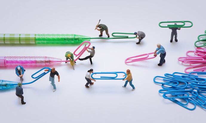 Brand management: The picture shows figures transforming ballpoint pen refills into paper clips.