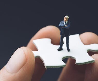 Interim manager on puzzle piece that symbolizes his accuracy of fit.