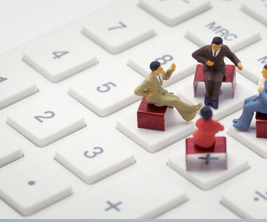 Digital reporting: The picture shows four figures sitting on a keyboard.