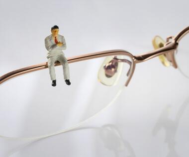 Cultural change: The picture shows a figure sitting on a spectacle frame.