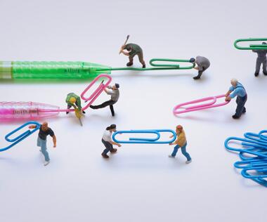 Brand management: The picture shows figures transforming ballpoint pen refills into paper clips.