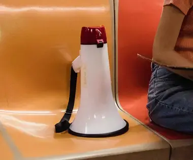 Interim Management Corporate Communications: The picture shows a megaphone on a subway seat.