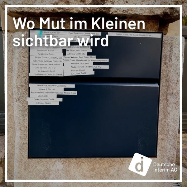 The picture shows a letterbox with many company signs on it.
