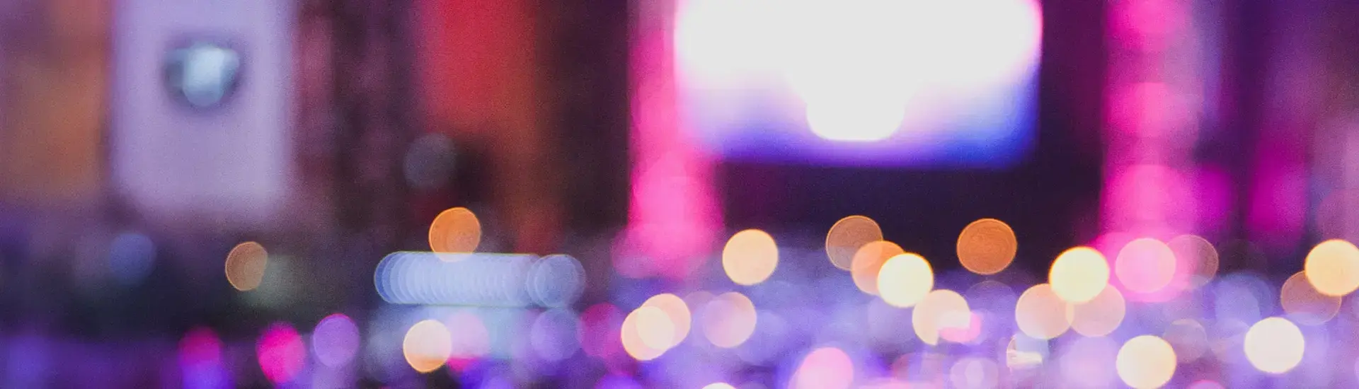 Interim Event Management: The picture shows a blurred stage taken from a distance.