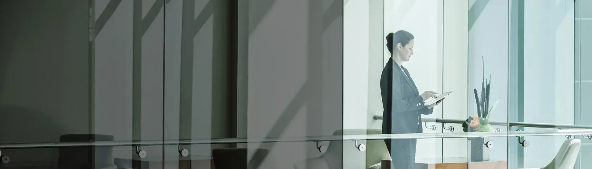 Interim CFO: Das Bild zeigt eine Interim CFO in einem modernen Büro mit viel Glas.