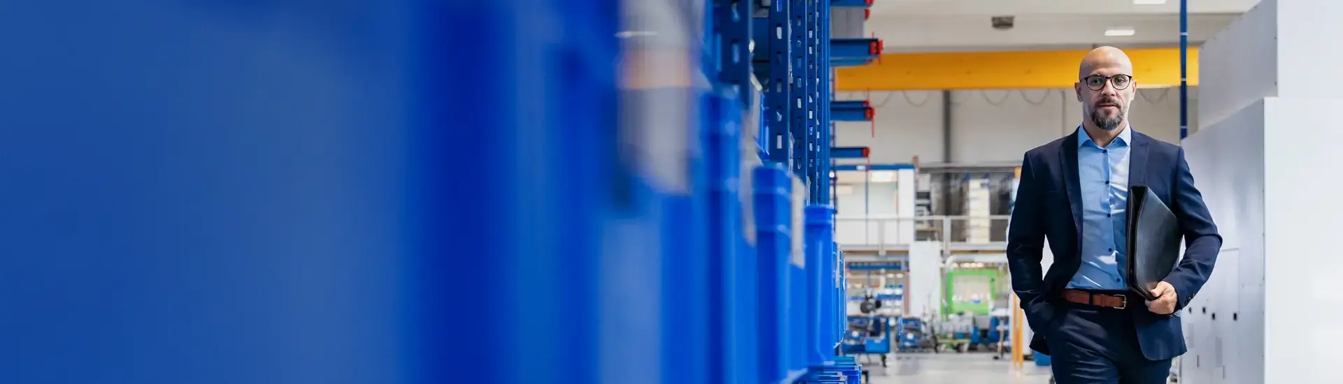 Interim COO: The picture shows an interim COO walking through a factory floor.