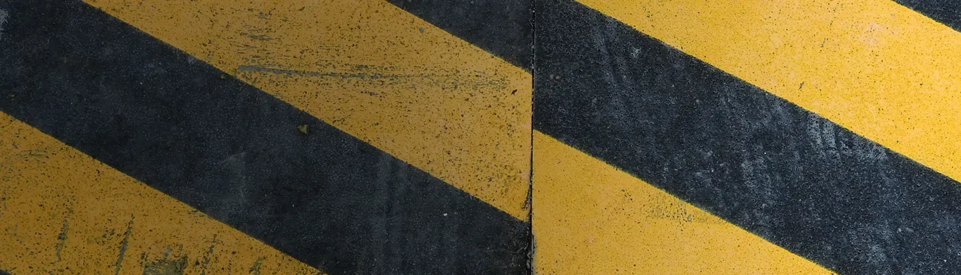 Interim risk management: The image shows a black and yellow warning stripe pattern.