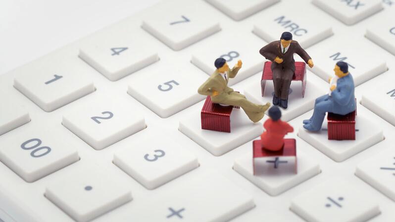 Digital reporting: The picture shows four figures sitting on a keyboard.