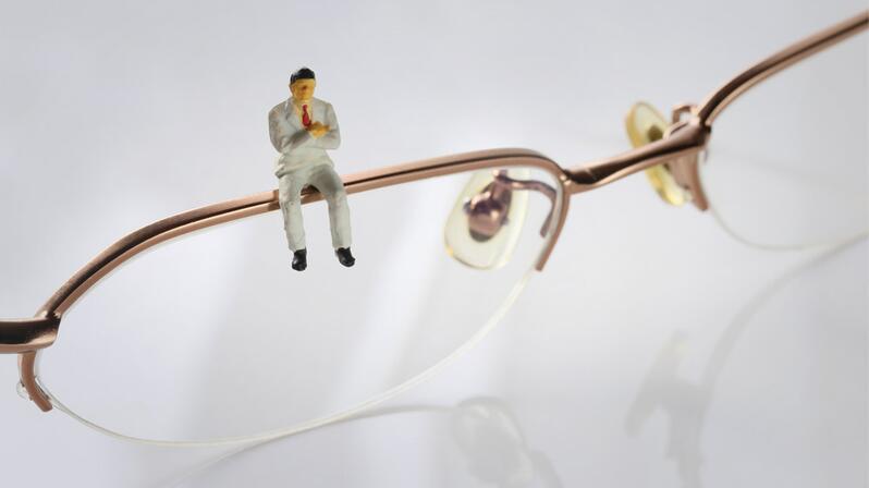 Cultural change: The picture shows a figure sitting on a spectacle frame.