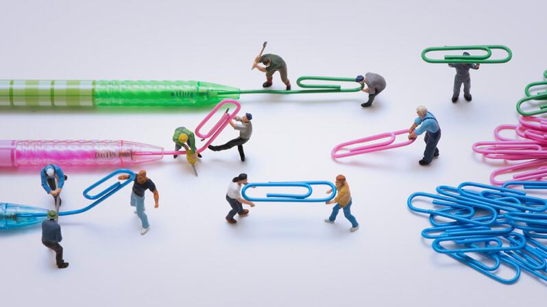 Brand management: The picture shows figures transforming ballpoint pen refills into paper clips.