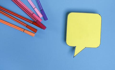 A speech bubble and pens as a symbol for the content of the page.